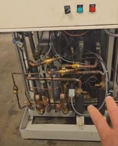 The image is taken from a video testimonial talking about the success of the APR Control installed on an oversized modular chiller in a DC restaurant.